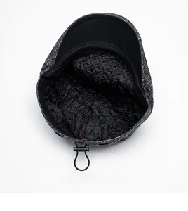 Detailed view of the quilted satin lining and adjustable drawstring on a winter flat cap