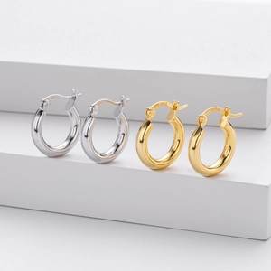 Detailed macro view showing the S925 hallmark on gold and silver hoop earrings