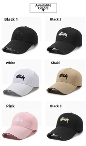 Detail view of cotton baseball caps in six colors with high-density letter embroidery