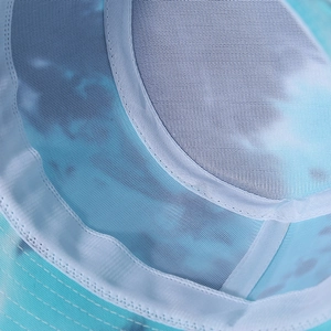 Detail view of tie-dye bucket hat featuring breathable white mesh lining and reinforced seams