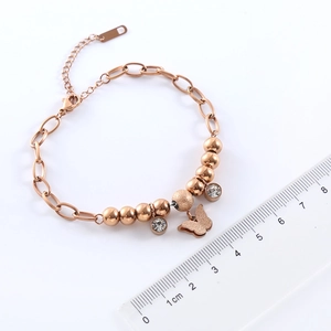 Rose gold beaded bracelet with butterfly pendant and crystal, size reference with ruler