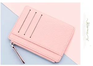 Close-up of pink litchi grain leather card holder with three card slots and silver zipper