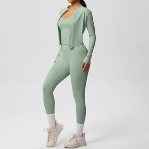 Detailed view of sage green three-piece yoga set with zip jacket and high waist leggings