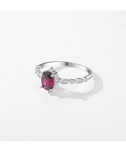 Macro detail of oval red gemstone ring with vintage marquise hollow silver band