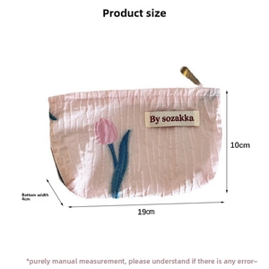 Detailed view of tulip embroidered makeup bag with 19x10x4 cm size specifications