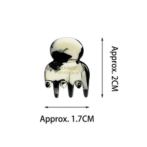Mini acetate hair claw clip with black and white marble pattern and gold France handmade logo