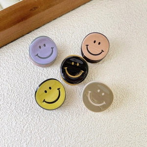 Detailed view of five mini acetate hair clips featuring smiley faces in various colors