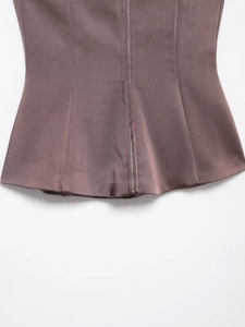 Close-up of the metal back zipper and seams on the taupe satin blazer top