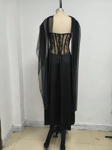Detail of floral lace corset top and sheer mesh shawl on a black evening gown