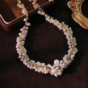 Vintage freshwater pearl cluster necklace with gold wire wrap on brown velvet