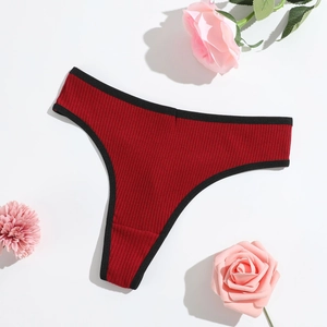 Detail of dark red ribbed cotton thong with black contrast trim and high-cut leg