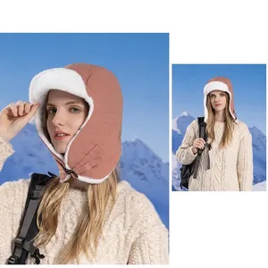 Pink quilted winter trapper hat with white faux fur lining and chin strap buckle