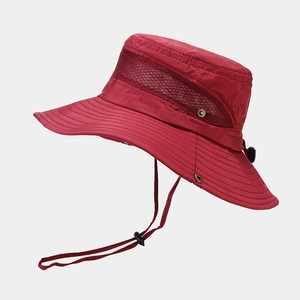 Detail of red outdoor hat featuring breathable mesh panels and adjustable chin strap