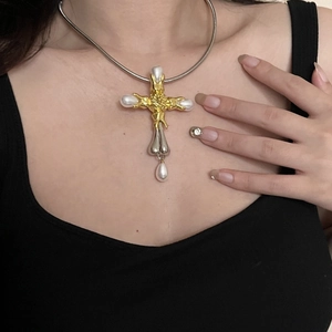 Vintage style cross pendant necklace with pearls on model in black top