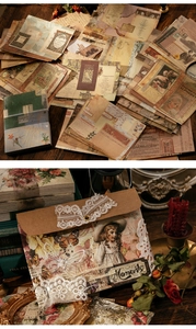 Macro shot of vintage scrapbooking paper set with envelopes, lace, and butterfly stickers