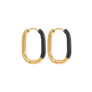 Macro shot of U-shaped gold-plated stainless steel earrings with black enamel detail