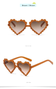 Detail of brown heart-shaped children's sunglasses with glitter scalloped frames