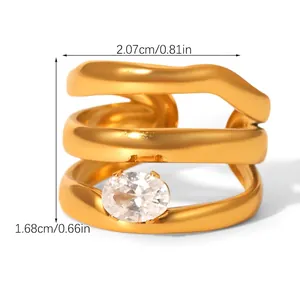 Macro detail of gold-plated layered wavy ring featuring an oval zircon center stone