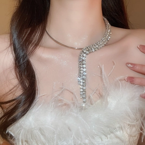 Detailed close-up of a silver rhinestone tassel choker necklace on a model for party wear