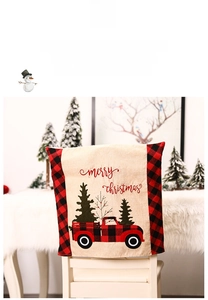 Detail of burlap Christmas chair cover with red truck and merry christmas text