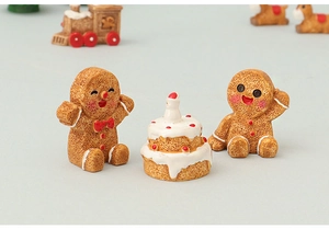 Miniature resin gingerbread men with a small birthday cake Christmas micro decor