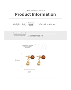 Detailed view of gourd drop earrings with gold copper finish and dark brown acrylic bead