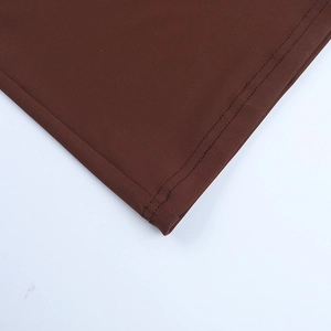 Detailed close-up of brown dress fabric showing professional double-line stitching craft