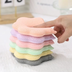 Close-up of colorful star-shaped facial sponges being pressed to show soft texture