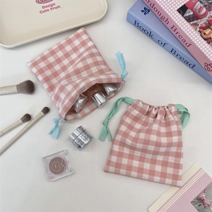 Detail of two-piece pink checkered drawstring storage bags in cotton canvas material