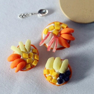 Macro shot of miniature fruit tarts with colorful resin berries for dollhouse decor