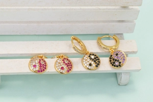 Macro shot of Yin Yang earrings with colorful cubic zirconia and gold-plated hardware