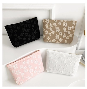 Detailed macro view of embossed 3D floral textures on colorful cosmetic storage bags