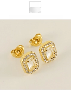 Macro view of gold halo stud earrings with emerald cut square zirconia stones