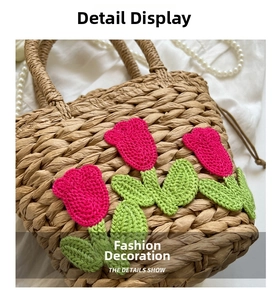 Detailansicht der handgefertigten Strohtasche mit rosa gehäkelten Tulpen-Applikationen