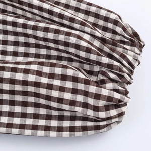 Women's plaid layered shirt with elastic cuffs and brown checkered pattern texture