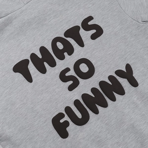 Detail of grey fleece hoodie showing 'THATS SO FUNNY' black art text print and soft fabric