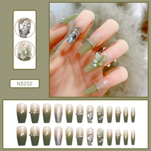 Detailed view of Coffin press-on nails in olive green gradient with 3D butterfly deco