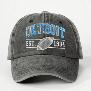 Close-up of vintage grey baseball cap featuring blue Detroit embroidery and football motif