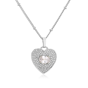 Macro detail of silver heart necklace featuring pave-set zircons and oval center stone