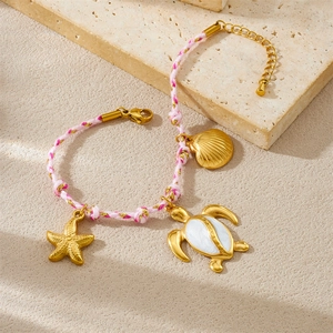 Bohemian ocean charm braided bracelet with golden turtle, starfish, and shell pendants