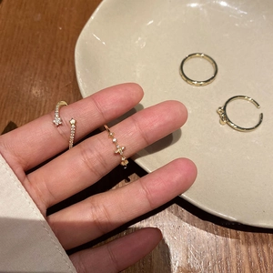 Elegant 4-piece set of gold-plated rings featuring bow and star designs with zircon stones