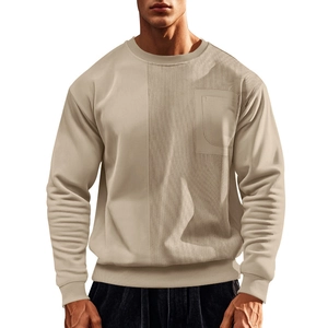 Detail of men's crewneck sweatshirt featuring corduroy patchwork and a chest pocket