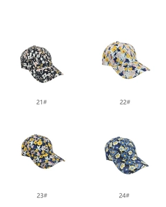 Detailed grid view of four floral print baseball caps in black, white, and blue colors