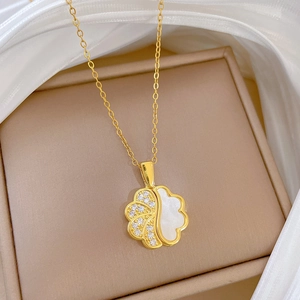 Golden flower necklace with white pearl shell and sparkling zircons on silk fabric