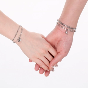 Detail of stainless steel double-layer magnetic heart bracelets for couples on hands
