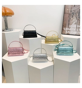 Quilted metallic mini handbags in black, gold, pink, silver and blue on minimalist stands
