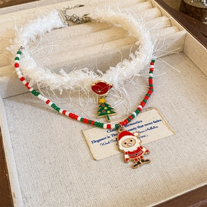 Detail of Christmas necklace set with white faux fur choker and beaded Santa pendant
