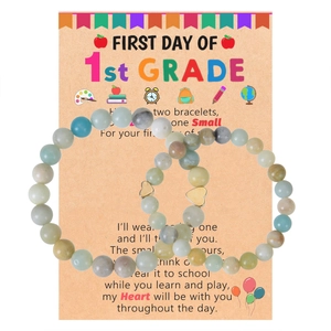 Detail of natural stone bead bracelets with heart charms on First Day of School card
