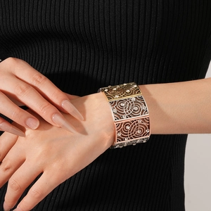 Detailed close-up of a wide hollowed vintage bangle with tricolor plating and crystals