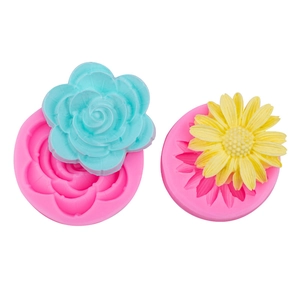 Pink silicone sunflower and daisy cake molds with colorful finished floral crafts
